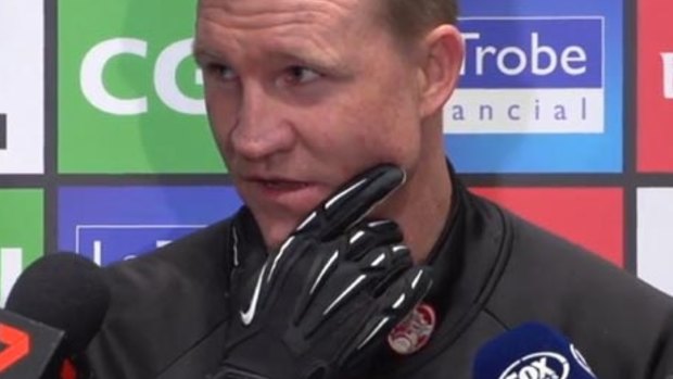 Gloved one: Nathan Buckley makes light of Travis Cloke's "illegal" glove.  