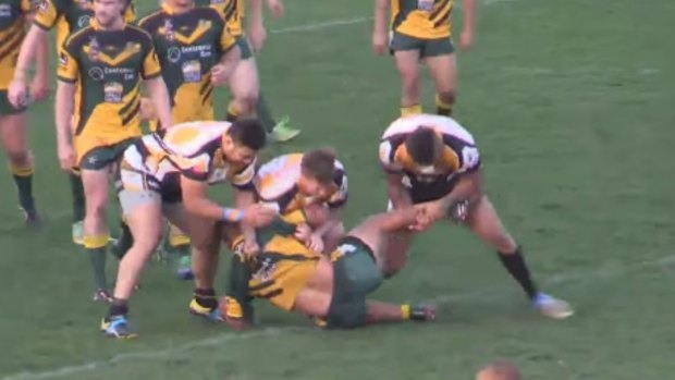 The tackle: Cessnock's Jared Edwards tackles Macquarie's Teason Fa'avae-Eli on Saturday.