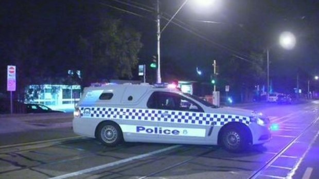 Police at the scene where a man was hit by a car in Kew overnight.