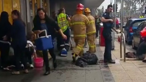 People carried buckets and Eskies full of water to help the victims of the Springvale bank fire.