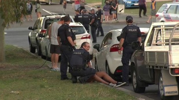 Police subdue a man after the football brawl.