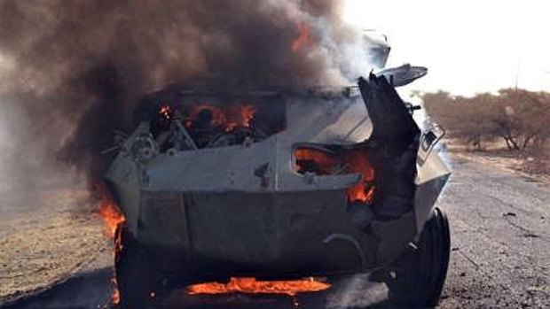A Boko Haram armoured vehicle burns after being set ablaze by the Nigerian military at Monguno.