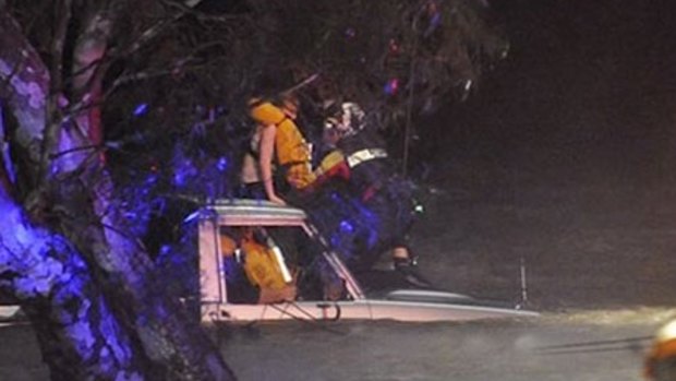 A man and girl being rescued from floodwaters at Inverleigh on Wednesday night.
