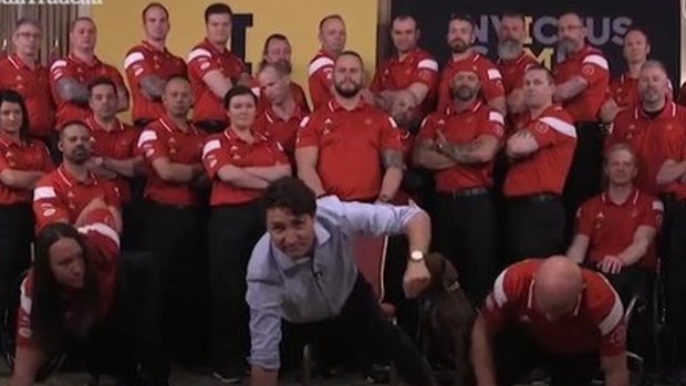 Justin Trudeau holds a one-arm plank for a good cause.