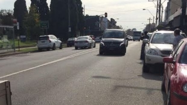 Store owner Mohamed Jafari managed to get this photo of the getaway car, a silver BMW (left, driving away).