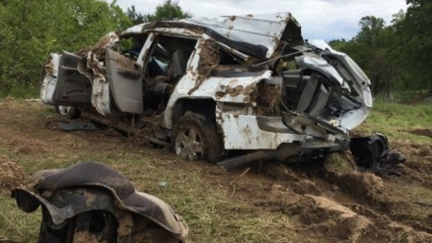 The family's SUV was overturned and crushed in the floods.