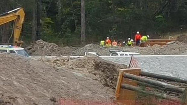 Construction workers at the site of the trench collapse at Coomera.