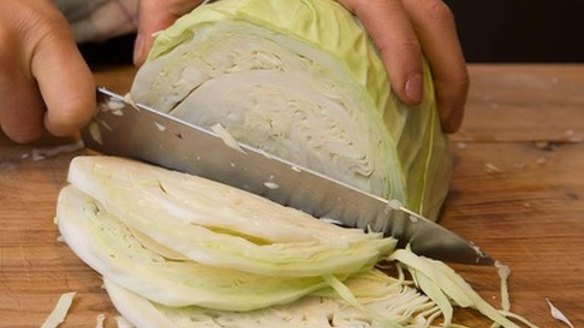 After you have removed the outer tough and dirty leaves of the cabbage, cut it into quarters, remove the core then slice into fine slivers.