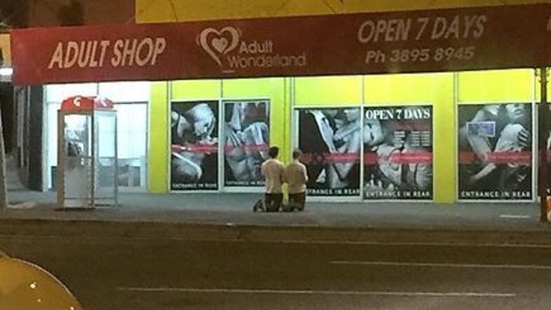 A photo posted on Reddit showing two men praying outside Annerley's Adult Wonderland last week.
