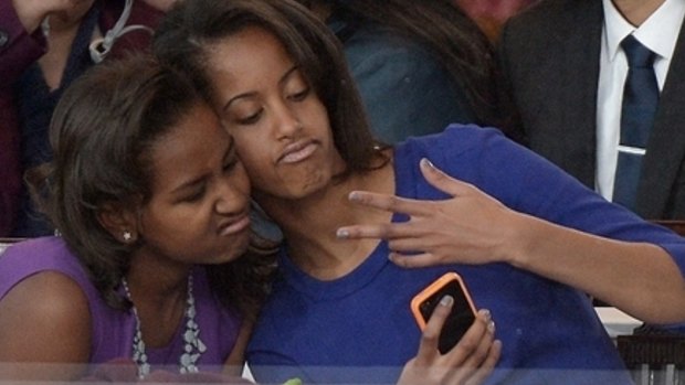 Teen 'tude: The First Daughters Sasha and Malia posing for selfies at Barack Obama's inauguration in 2013.