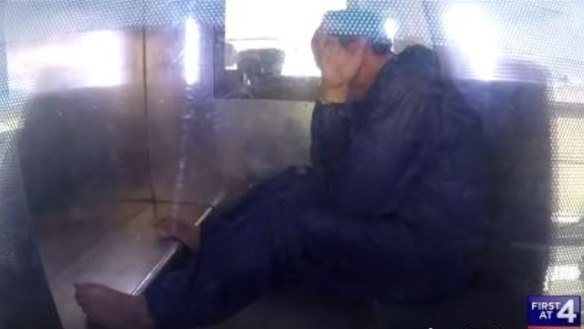 Ali Mohammed Moussa, 43, in the back of a police truck after leaving Riverstone Police Station. 