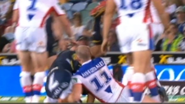 The tackle in question: Beau Scott brings down  Johnathan Thurston.