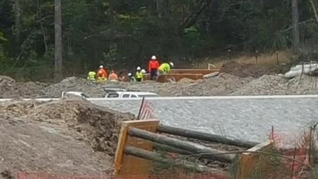 Construction workers at the site of a trench collapse at Coomera.