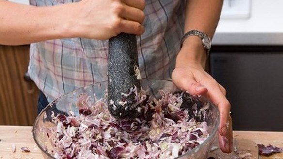 After the salted mix has rested for 10-20 minutes, pound it to release liquid from vegetables.