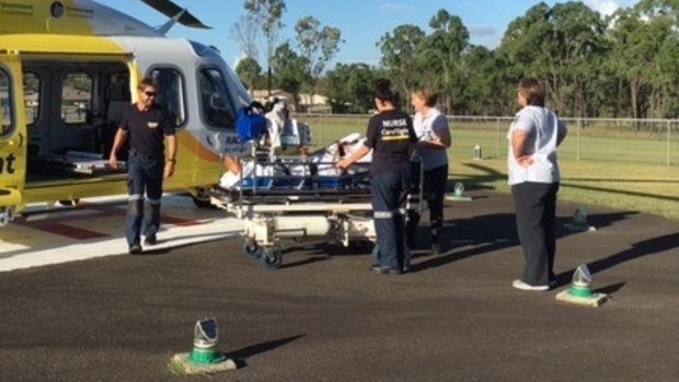 An RACQ CareFlight crew helps a man in his 50s who was trampled by a cow.