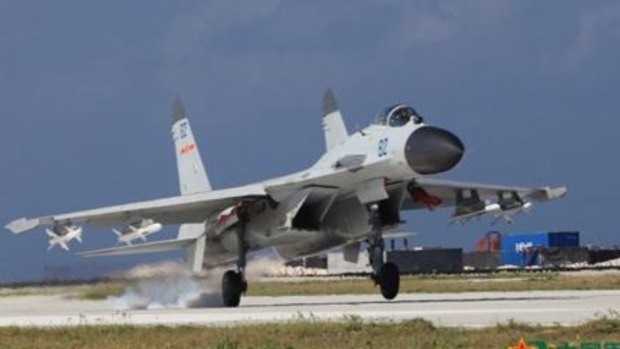 A J-11 fighter takes off for exercises over South China Sea.