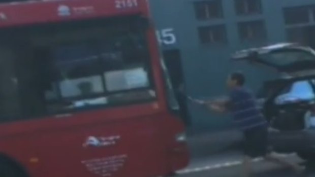 The moment an enraged driver took to the bus with a shovel.