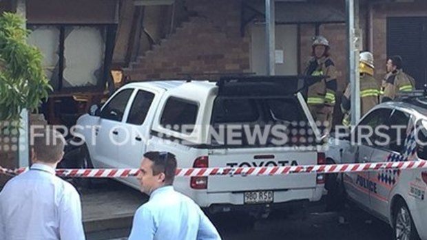 The ute breached the wall of the Mudgeeraba police station and also hit a police car.