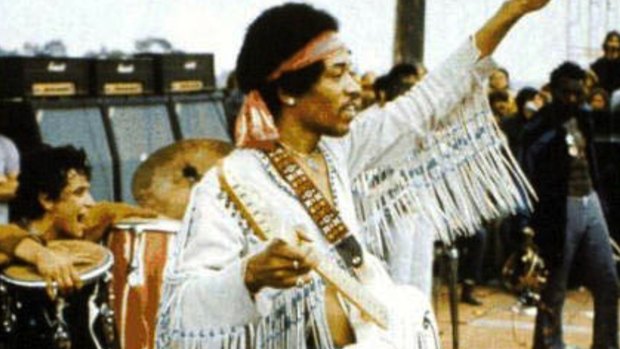 Jimi Hendrix acknowledges the crowd in this scene from the film Woodstock, Three Days of Peace and Music - Director's Cut.