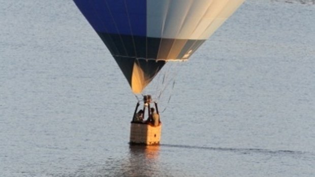 An RAAF hot-air balloon skimming Lake Burley Griffin about 6.30am Wednesday morning.  