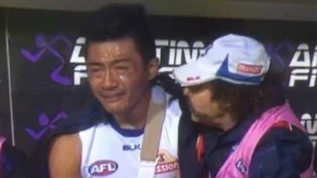 Devastated: Lin Jong on the bench after breaking his collarbone in the elimination final.