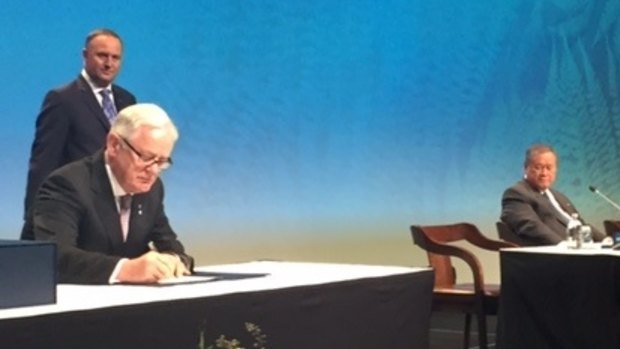 Then Trade Minister Andrew Robb signs the TPP for Australia in February. 