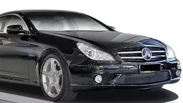The man's car is a 2009 Mercedes-Benz CLS63 Coup, similar to this.