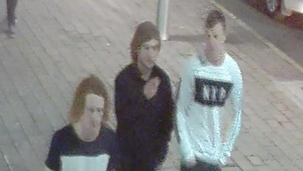 The alleged offender (middle) pictured with two other men.