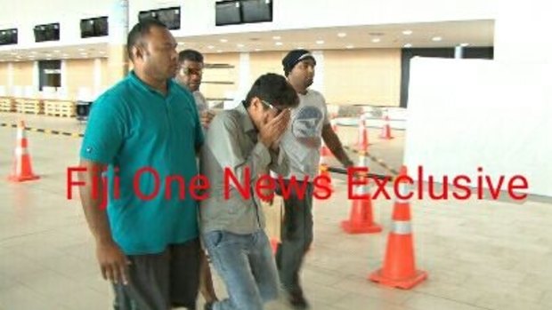 A Fijian media outlet has published pictures of Loghman Sawari being taken to the airport.