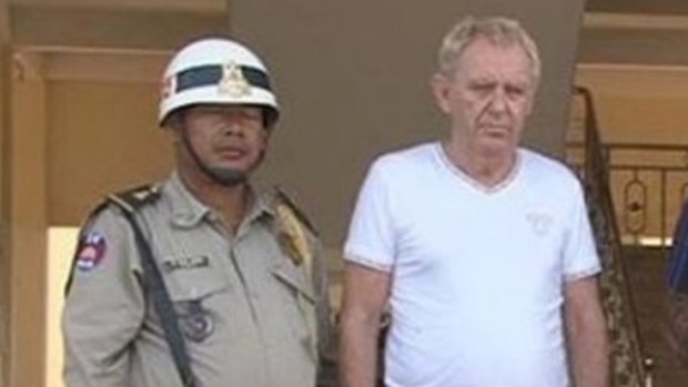 Mr Eglitis under arrest in the Cambodian town of Siem Reap last year.