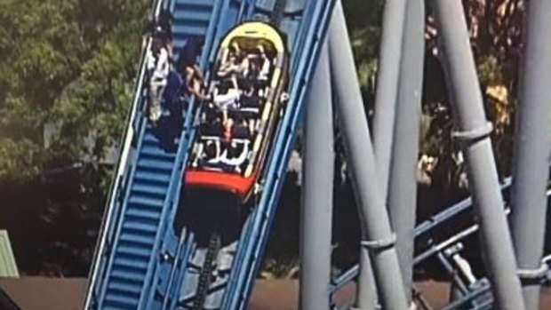 Several roller-coaster riders are helped out of the ride at Sea World.