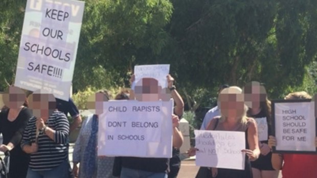 Parents protesting about convicted child sex offenders being allowed to return to school. 