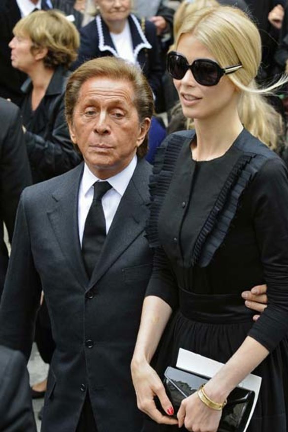 Italian designer Christian Valentino (L) and German model Claudia Schiffer attend the funeral service for late fashion designer Yves Saint Laurent in Paris June 5, 2008.  