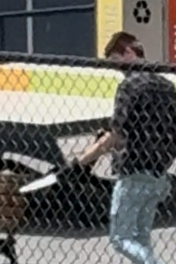 A plained clothes police officer holds the knife following the altercation with the boy.