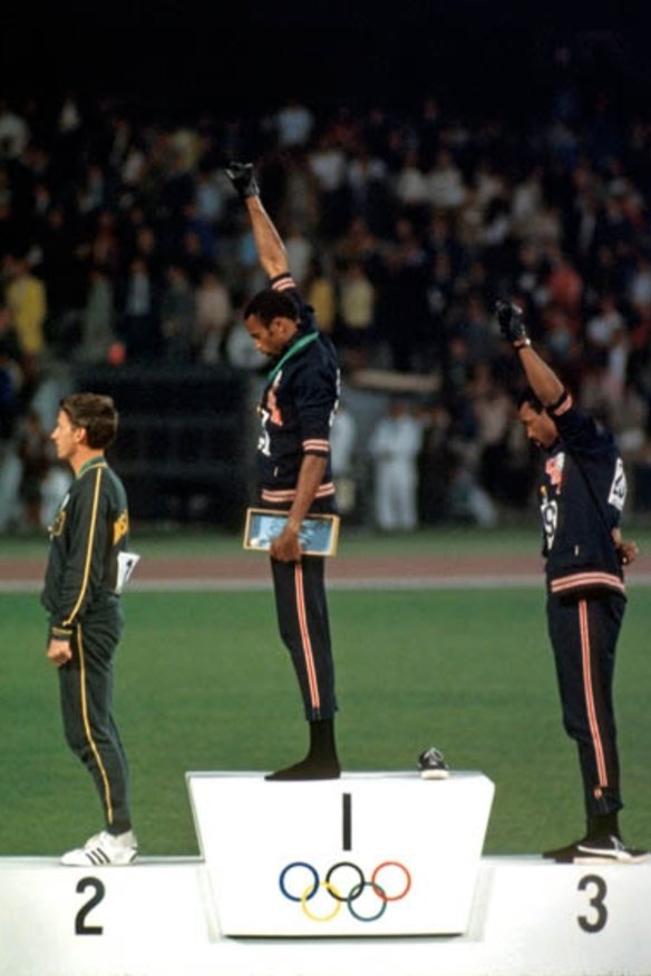 Australia's Peter Norman on the medal dais at the 1968 Olympics in Mexico City as US athletes Tommie Smith  and John Carlos give the Black Power salute.