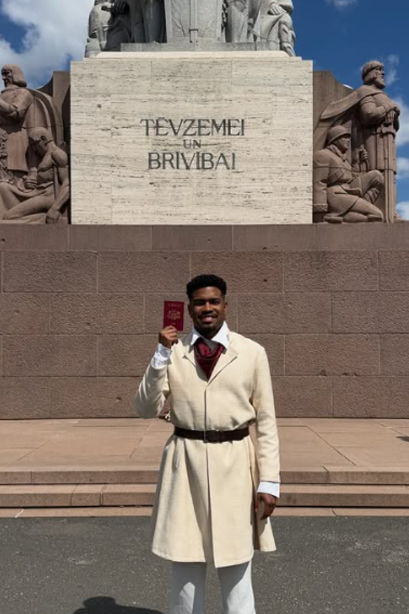 Felipe Gabriel Xavier celebrates Latvian citizenship in traditional attire.