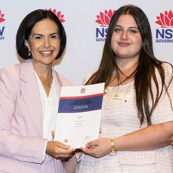 Saleem receiving her HSC certificate for excellence from Education Minister Prue Car.