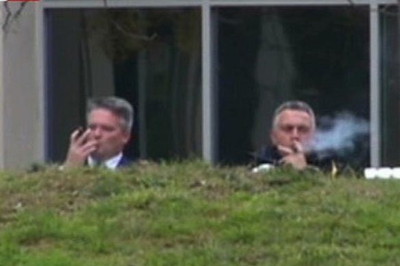 Mathias Cormann and Joe Hockey kick back with a cigar in 2014.