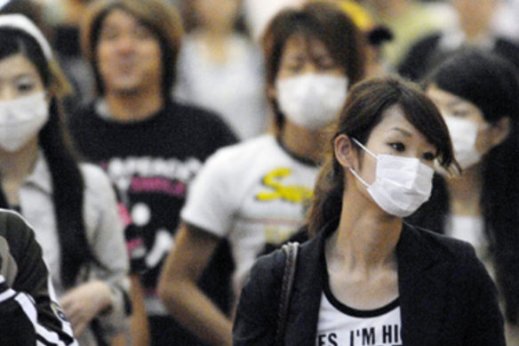 Shoppers in Japan wear masks as precaution against germs.