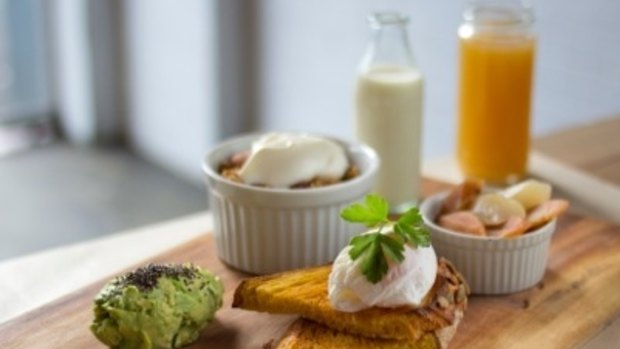 Rustica Bakery's breakfast board comprises housemade granola with  yoghurt,  fruit, a poached egg on  sourdough, crushed avocado and a bottle of Finn cold-pressed juice.
