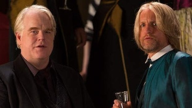 The late Philip Seymour Hoffman (left) and Woody Harrelson also appear in the latest in series, out November. 