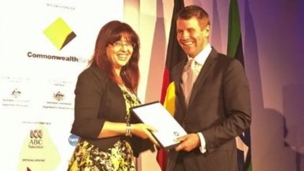 Eman Sharobeem receives her commendation in the Australian of the Year Award from then-NSW premier Mike Baird.