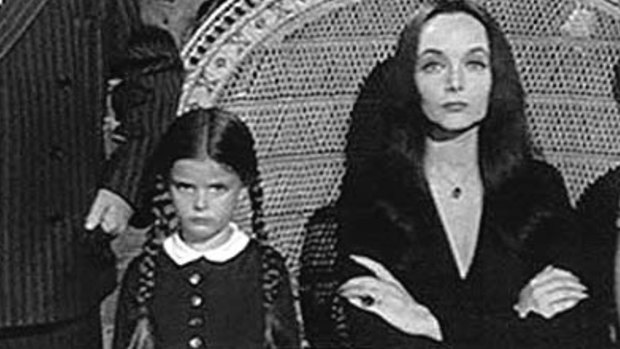 In <i>The Addams Family</i>(1964-1966). TV series. [L-R, behind the chair]: Uncle Fester (Jackie Coogan); Lurch (Ted Cassidy); Grandmama Addams (Blossom Rock). [L-R, front row]: Gomez Addams (John Astin); Wednesday (Lisa Loring); Morticia Addams (Carolyn Jones); Pugsley (Ken Weatherwax). 