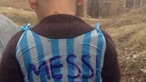 Ultimate fan: A young boy is pictured in a hand-made Leo Messi shirt.