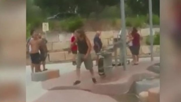 A man staggers through an Ipswich playground after being stabbed, allegedly by a 20-year-old woman.