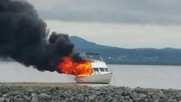 A man was taken to hospital after this boat fire on Redland Bay on Monday morning.