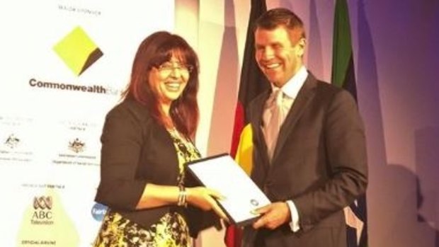 Eman Sharobeem receives her commendation in the Australian of the Year Award from then-NSW premier Mike Baird.