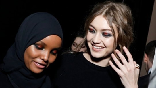 Models Halima Aden and Gigi Hadid are seen backstage ahead of the Alberta Ferretti show.