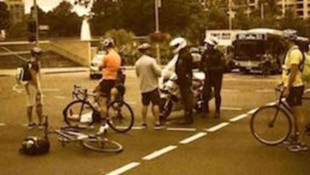 A witness claims the police motorcyclist pushed the cyclist off his bike.