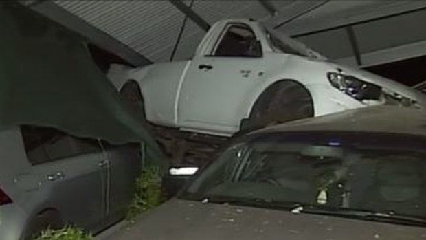 A ute has slammed into a residential carport in Holland Park on Sunday morning, landing on top of two other cars and causing the structure to collapse.